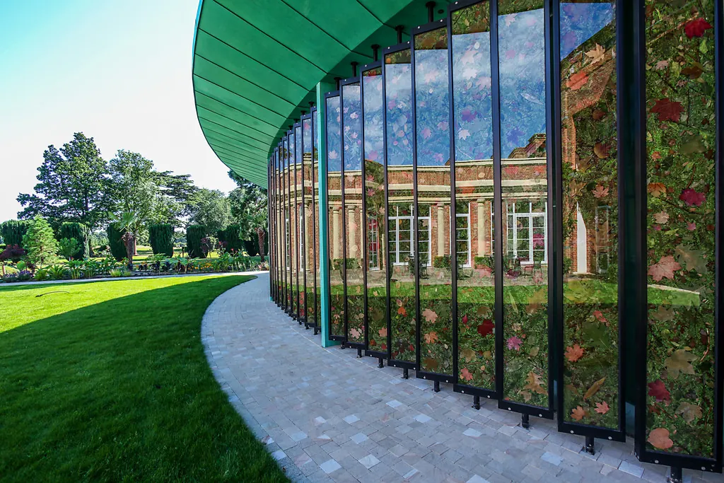 The Grove Hotel Cedar Suite — bespoke rotating glass fin facade reflecting the surrounding hotel landscape