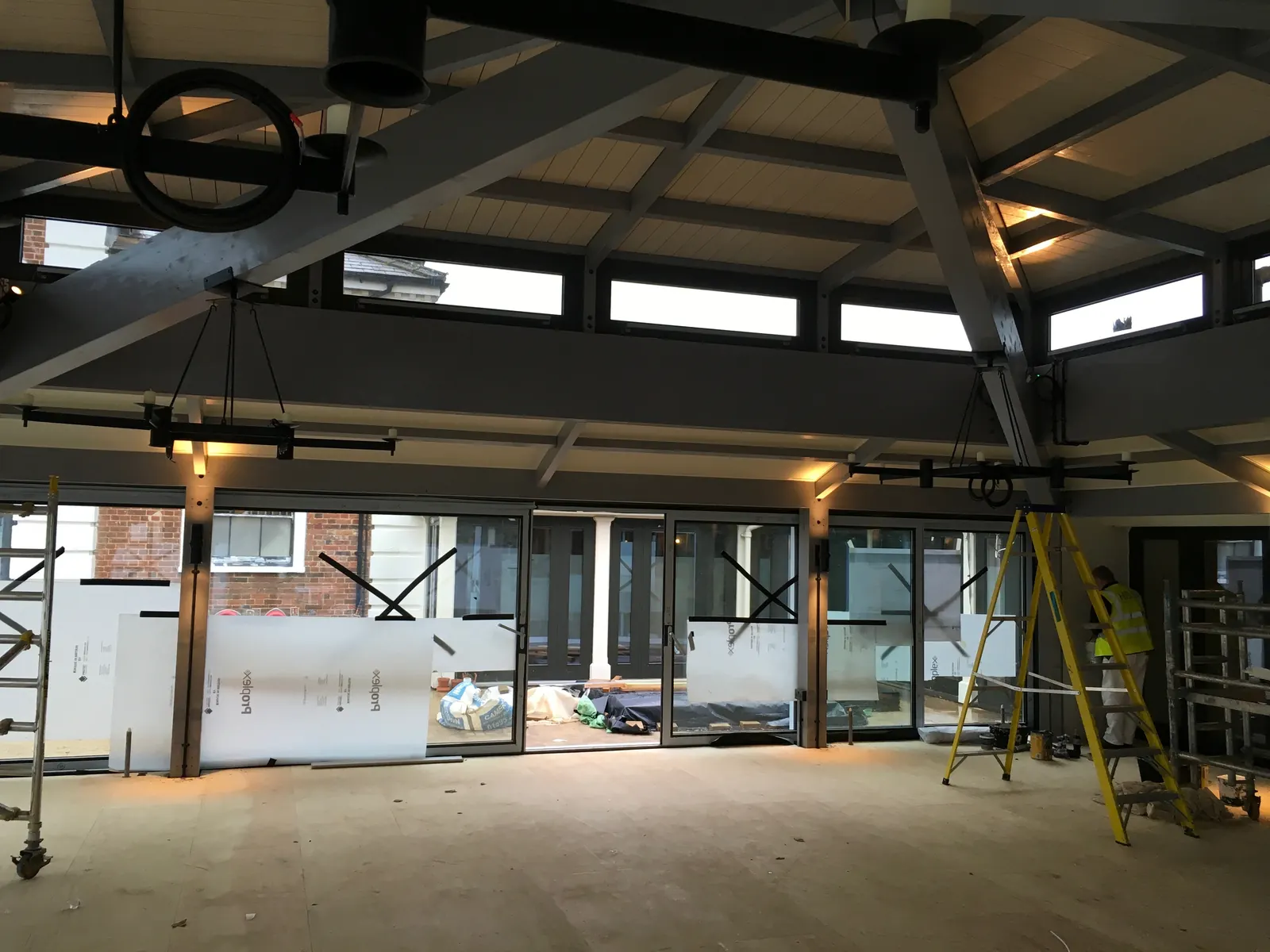 The Grove Hotel Players' Lounge & Golf Clubhouse — glazing installation under the completed timber roof structure