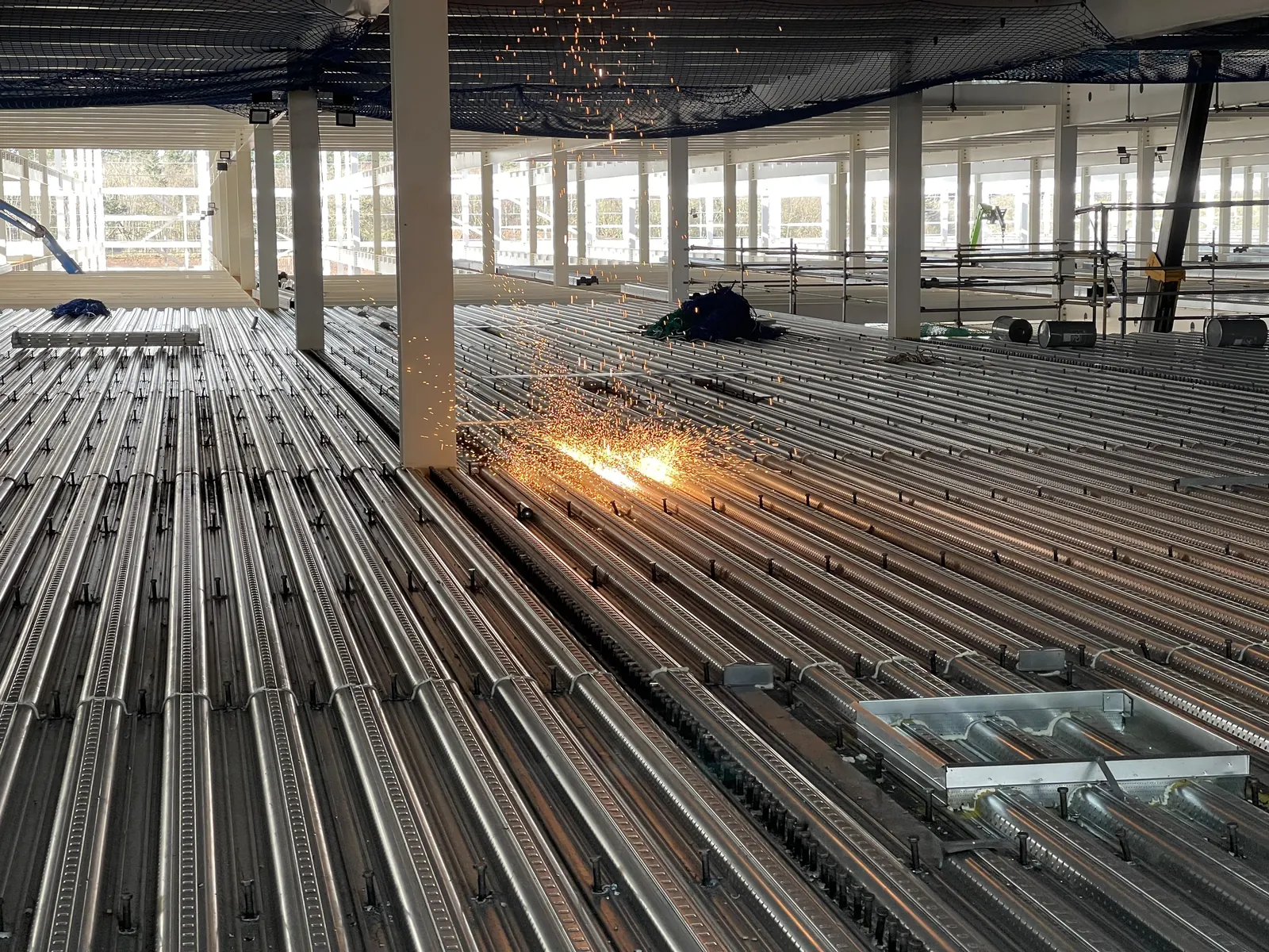 Craig Garbutt — metal deck stud welding before concrete slab pour on a £110 million international retail distribution centre, large-scale structural frame construction programme