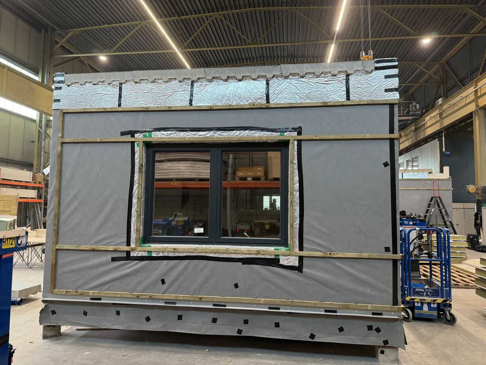 Craig Garbutt — MMC factory: volumetric unit external wall build-up with insulation wrap and window installation