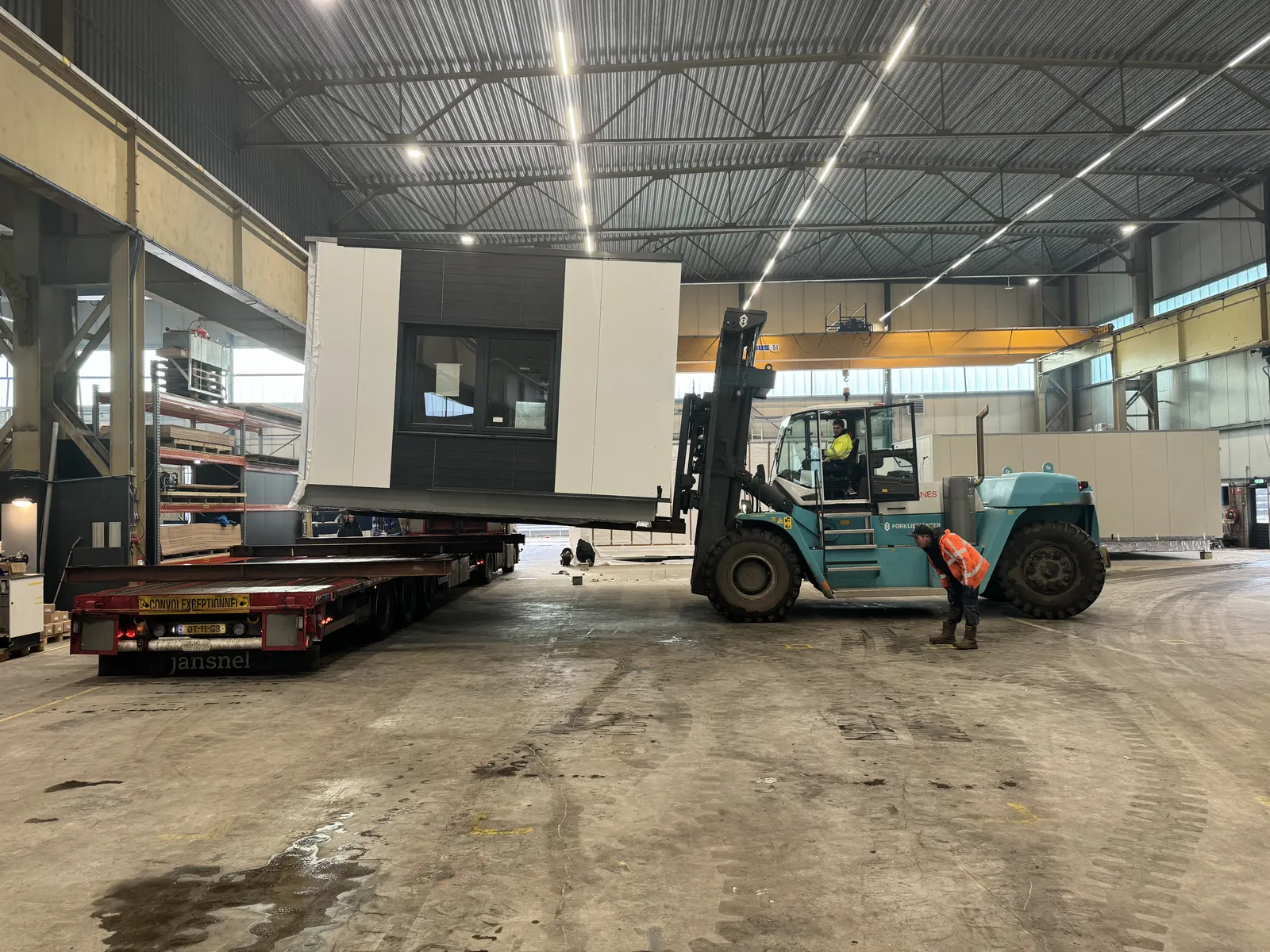 Craig Garbutt — MMC factory: completed volumetric unit being loaded onto a flatbed trailer by forklift