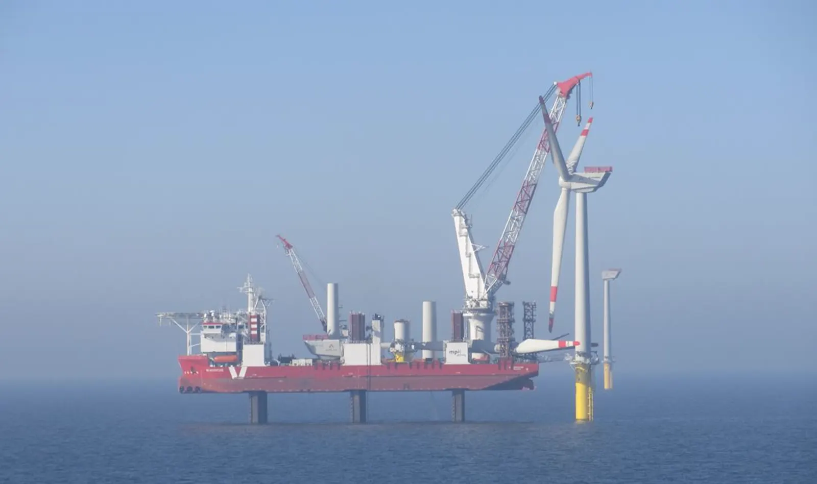 Trianel Windpark Borkum — jack-up vessel installing turbine in low-visibility conditions, demonstrating programme scale