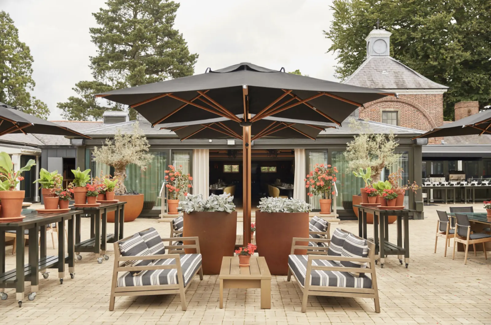 The Grove Hotel Players' Lounge & Golf Clubhouse — completed terrace with outdoor dining and lounge furniture