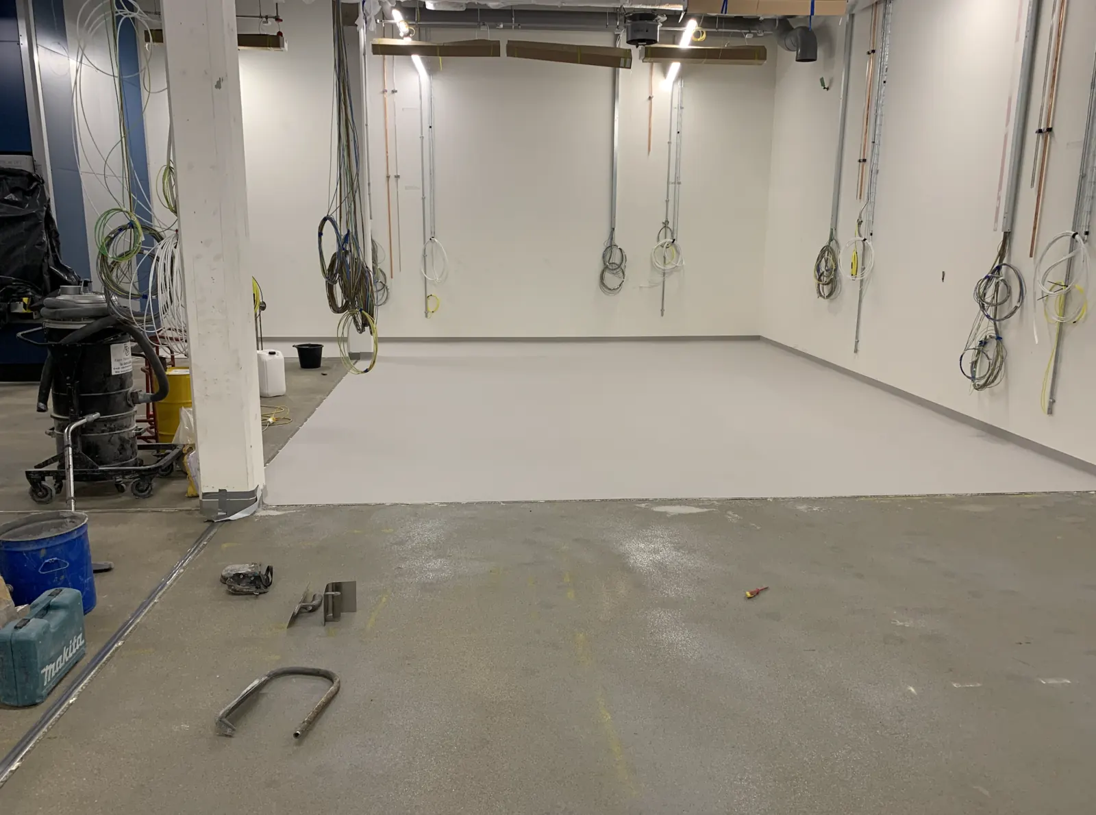 Advanced Materials Testing Facility — resin floor being laid alongside services first-fix