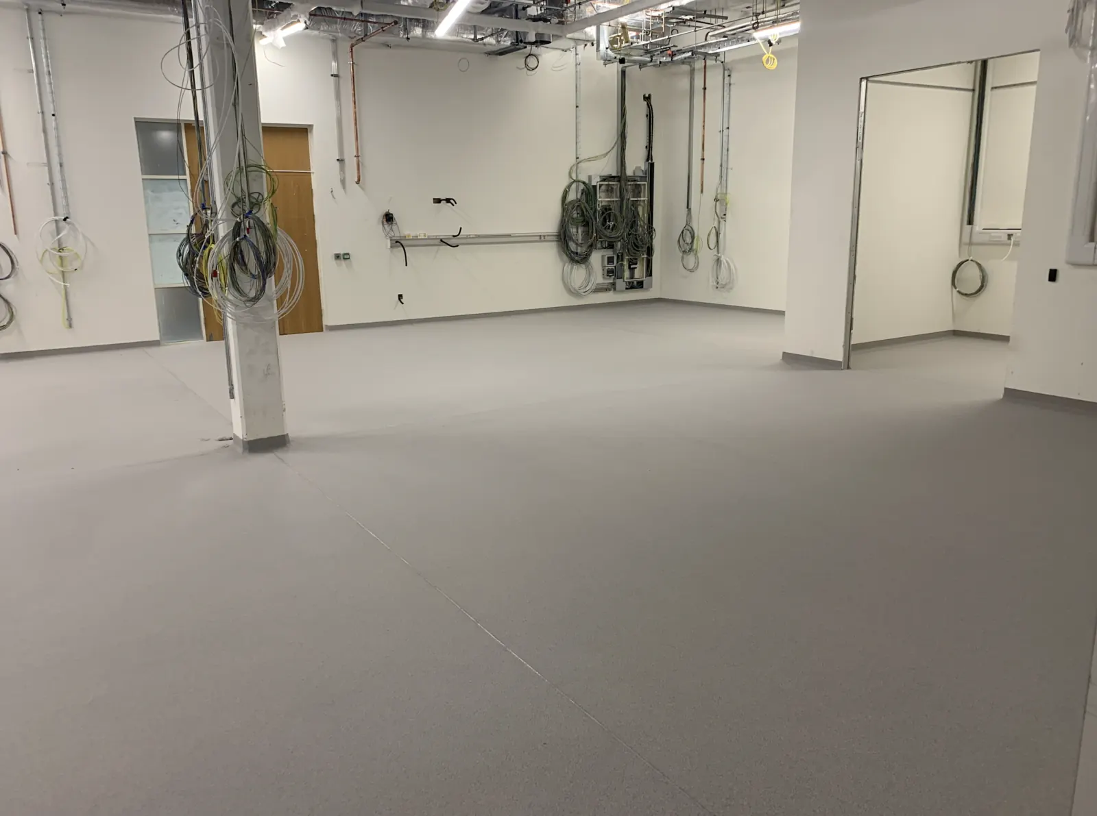 Advanced Materials Testing Facility — completed floor slab with MEP first-fix overhead