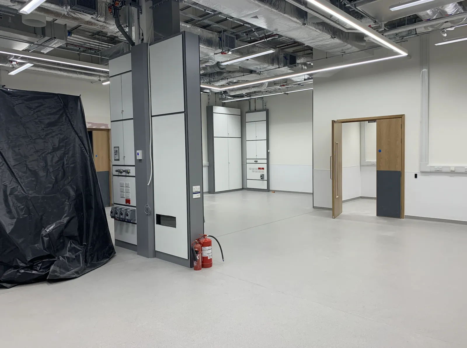 Advanced Materials Testing Facility — precision testing equipment sheeted for protection during ongoing fit-out