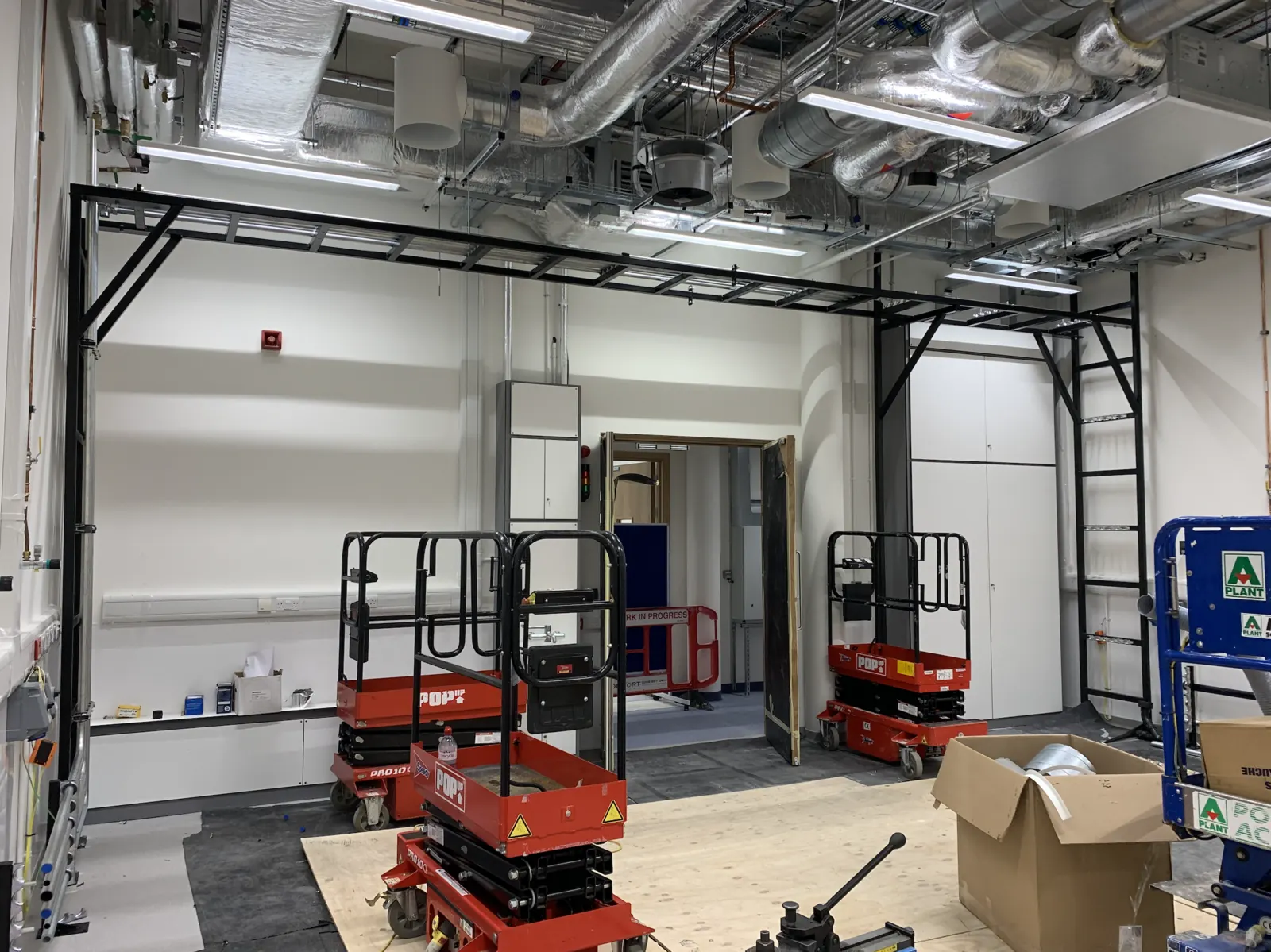 Ladder racking system installed overhead ahead of plant install, mobile access platforms below